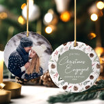 First Christmas Engaged Photo Engagement Ceramic Ornament<br><div class="desc">Looking for the perfect way to commemorate your engagement during the holiday season? Our First Christmas Engaged Photo Engagement Ceramic Ornament,  featuring a winter pine and holly berries design,  is the perfect sentimental addition to your festive celebrations.</div>