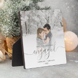 First Christmas Engaged Photo Silver Script Plaque<br><div class="desc">Commemorate your engagement with this beautiful modern keepsake plaque. The text reads "Our first Christmas engaged, " with the word "engaged" in elegant silver faux foil handwriting script with flourishes before and after. Replace the sample image with your favourite photo, and add your names and the year. A white gradient...</div>