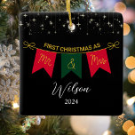 First Christmas Married As Mr. And Mrs Gold Script Ceramic Ornament<br><div class="desc">Celebrate your Mr. and Mrs. First Christmas with this elegant Couples First Christmas Ornament. Set on a sleek black background adorned with silver stars, this ornament features the words "Mr. and Mrs." in luxurious gold script, accented by classic red and green Christmas colours. Personalise it with the couple's names for...</div>