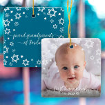 First Hanukkah Grandparents Baby Photo Star David Ceramic Ornament<br><div class="desc">“First Hanukkah.” A playful visual of white Stars of David, snowflakes and handwritten script typography with customised year, overlaying the photo of your choice, help you usher in Hanukkah and New Year. On the back, additional white Stars of David, snowflakes and handwritten typography with “proud grandparents of baby’s name” overlay...</div>