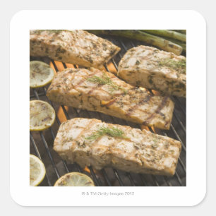 Fish and asparagus cooking on grill square sticker