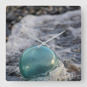 Fishing Float Surrounded By Surf Square Wall Clock
