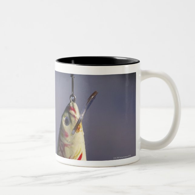 fishing lure in front of water Two-Tone coffee mug (Right)