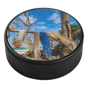 Fishing nets drying on the beach hockey puck