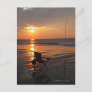 Fishing rod and chair by the ocean in the early postcard