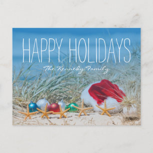 Five starfish on a beach with a Santa hat Holiday Postcard
