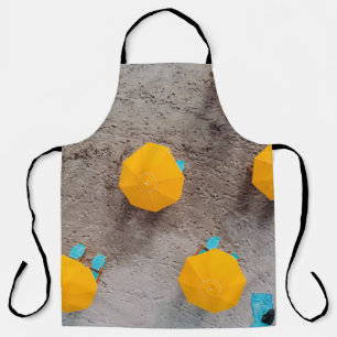 Five yellow umbrellas on sand at daytime apron