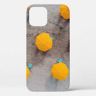 Five yellow umbrellas on sand at daytime iPhone 12 case