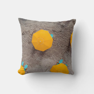Five yellow umbrellas on sand at daytime cushion