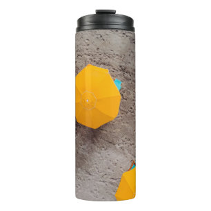 Five yellow umbrellas on sand at daytime thermal tumbler