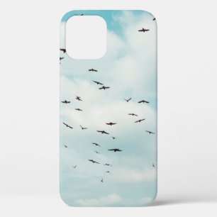 Flock of grey dove fly on vintage blue sky. above, iPhone 12 case