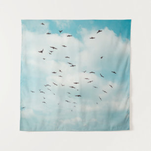 Flock of grey dove fly on vintage blue sky. above, tapestry
