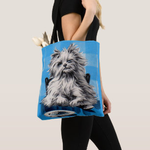 floofy dog eating at the table tote bag