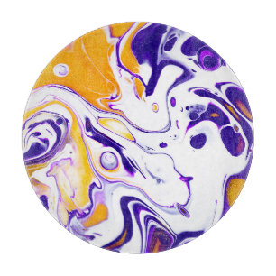 Fluid art texture: swirling paints. cutting board