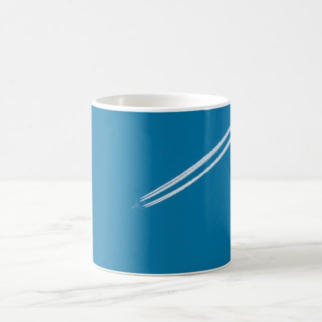 Flying aeroplane on a blue sky background coffee mug (Center)