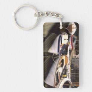 Fog surrounds four boats docked. key ring