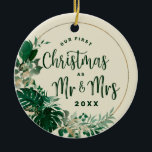 Foliage First Christmas as Mr & Mrs Newlywed Photo Ceramic Ornament<br><div class="desc">Tropical Foliage Trendy Greenery and Gold Leaves Circle Frame Custom Wedding Photo Our First Christmas as Mr. and Mrs. Holiday Ornament - with tropical leaf border, Brushed Marker typography, and your Custom text. Add your special wedding day photo to the backside! in a bold colour palette of rich greens, emerald,...</div>