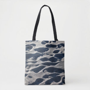 Foot prints on sand during daytime tote bag