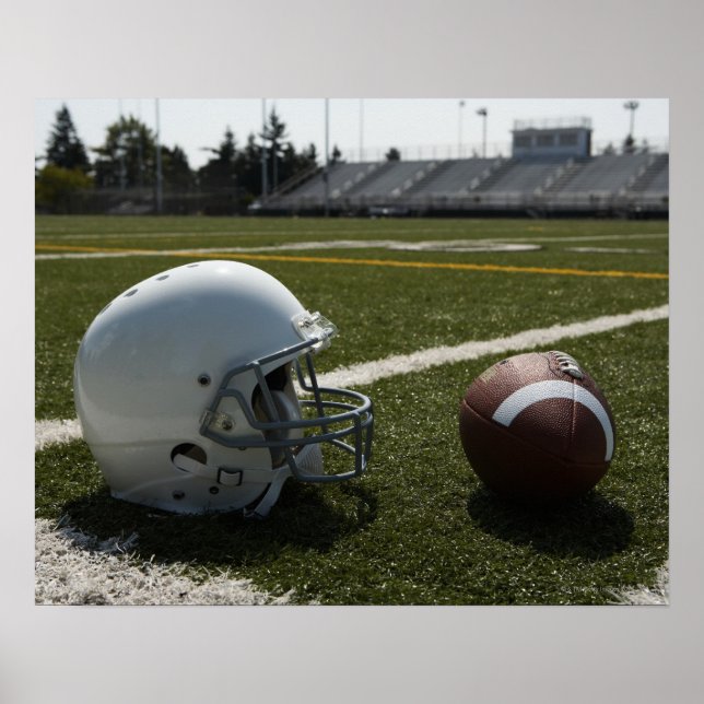 Football and football helmet on football field poster (Front)