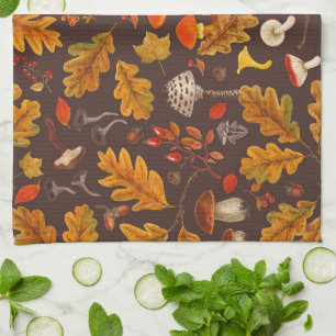 Forest mushrooms and autumn flora on brown tea towel