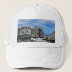Fortress walls, rocky coast and sea in Croatia Trucker Hat