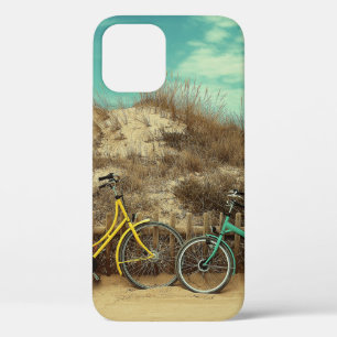 Four assorted-colour commuter bikes near hill at d iPhone 12 case