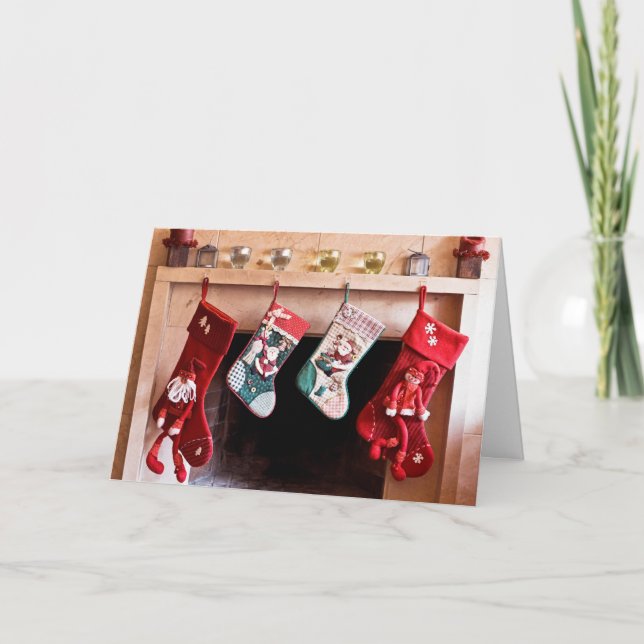Four Christmas stockings hanging on fireplace Holiday Card (Front)