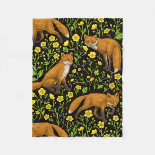 Foxes and buttercups on black fleece blanket