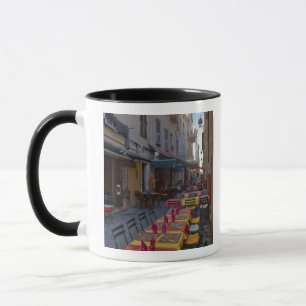 France, Corsica. Tables of cafe set up in narrow Mug