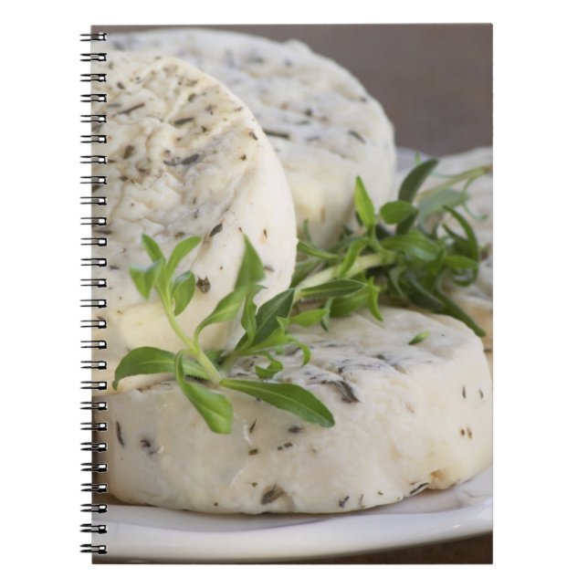 French goat cheese - chevre - with herbs on a notebook (Front)