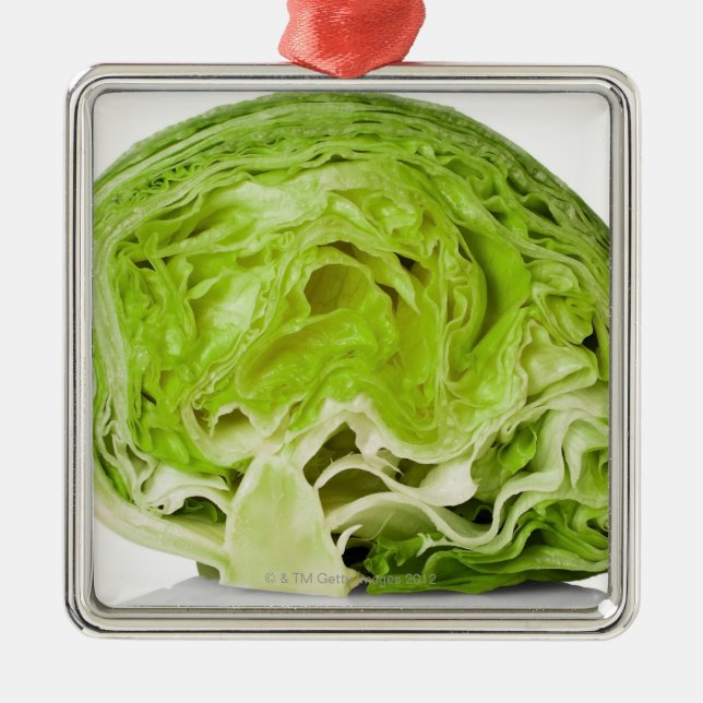 Fresh iceberg lettuce cut in half, on white metal ornament (Front)