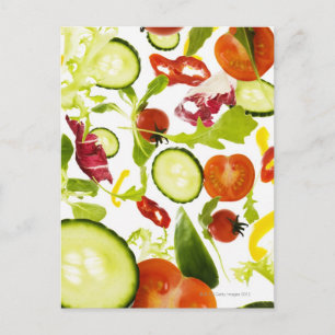 Fresh mixed salad vegetables falling to camera postcard