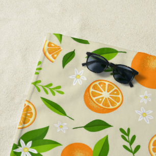 Fresh oranges with flowers and leaves beach towel