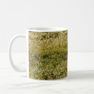 Fresh spring green grass background, with bokeh ef coffee mug
