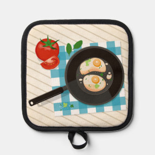 Fried eggs in pan with tomato and greens pot holder