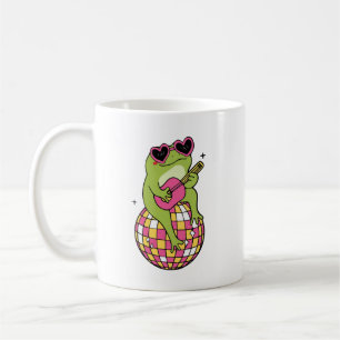 Frog sitting on dance ball playing guitar coffee mug
