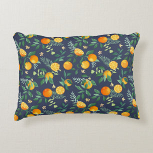 Fruits oranges with tropical leaves and flowers on decorative cushion
