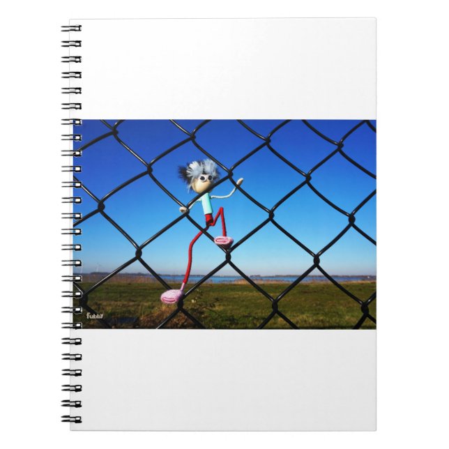 Fubby puppet climbing up the fence. notebook (Front)