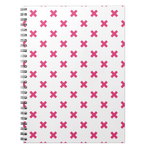 Fuchsia cross stitches on white notebook