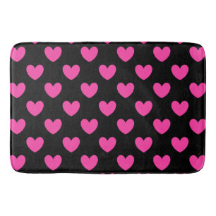 Fuchsia pink polka hearts on black bath mat