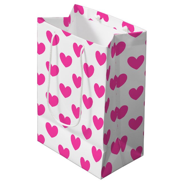 Fuchsia pink polka hearts on white medium gift bag (Front Angled)