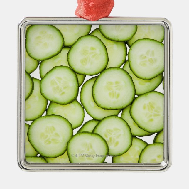 Full frame of sliced cucumber, on white metal tree decoration (Front)