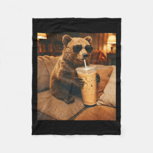 Funny animal bear drinking iced coffee on couch fleece blanket
