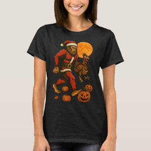 Funny Bigfoot In A Santa Suit Carrying A Turkey Ha T-Shirt