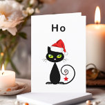 Funny Black Sitting Santa Claus Christmas Cat Holiday Card<br><div class="desc">Shows a black cat with green eyes and curly tail. The cat wears a red Santa Claus hat and has a Christmas star ornament hanging from its tail. The text above reads "Ho, " which is an unenthusiastic "ho ho ho." Customise and personalise the inside text, which reads "Man, it's...</div>