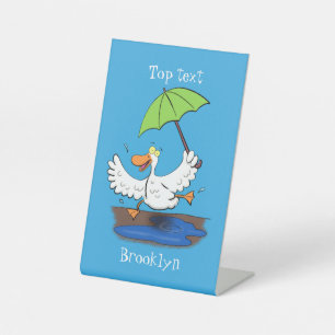 Funny duck with umbrella dancing cartoon pedestal sign