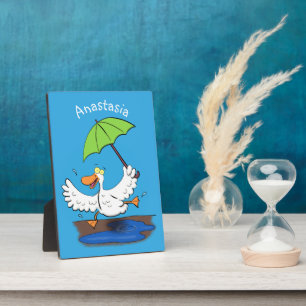 Funny duck with umbrella dancing cartoon plaque