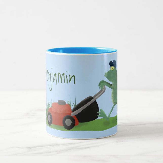 Funny green frog mowing lawn cartoon Two-Tone coffee mug (Center)