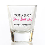 Funny Hot At 60 Birthday Shot Glass<br><div class="desc">Funny shot glasses for her 60th birthday part. "Take a shot she's still hot" is written in black typography and a hot pink script.</div>