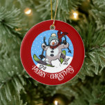 Funny Snowman Merry Christmas! Skiing Cartoon Ceramic Ornament<br><div class="desc">A jolly snowman on a ceramic ornament for your Christmas tree. Use "Personalise this template" to tweak the "Merry Christmas!" text and create a unique, customised gift. Featuring a cute snowman with a carrot nose and coal eyes, dashing through the snow on skis, in woolly winter hat and tartan scarf,...</div>